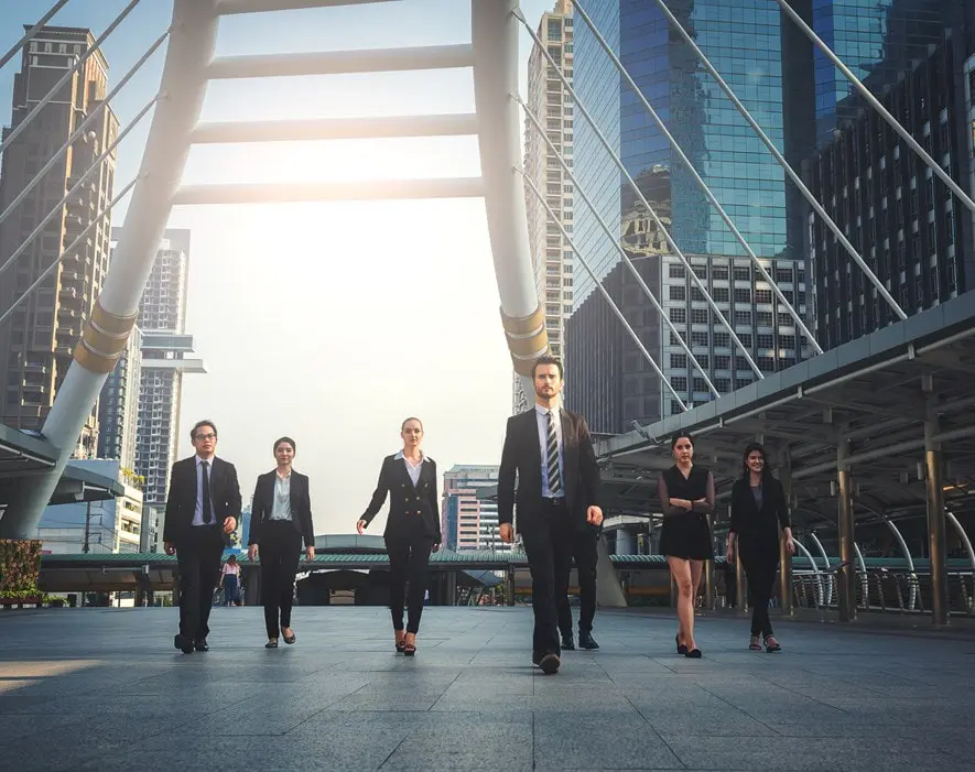 A Group Of Financial Professionals walking confidently with their team